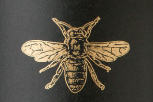 Closeup of gold bee logo on Meadowcroft wine label